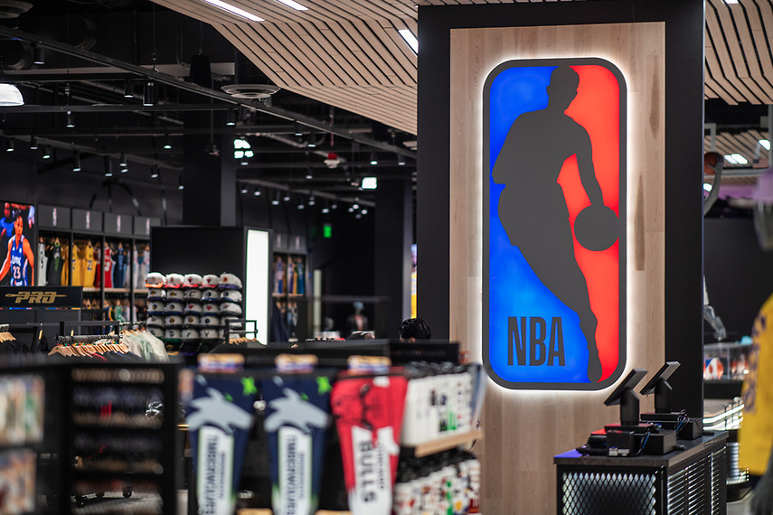 NBA Backlit Logo on Wood Slat Wall Near Checkout Counter